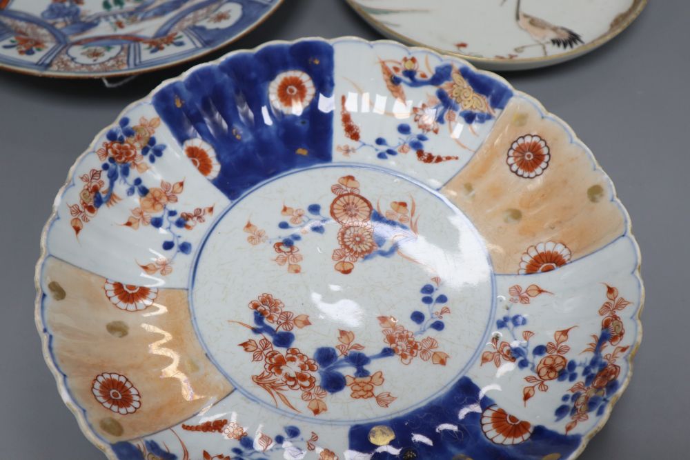 A 17th century Arita crane dish and an 18th century Chinese Imari fluted dish and similar soup plate, largest diameter 26cm